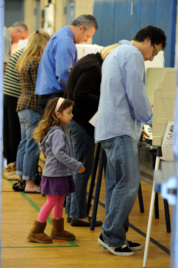 At the Palisades Recreation Center, Gisele (4) waited as her dad Rich Genow cast his ballot.